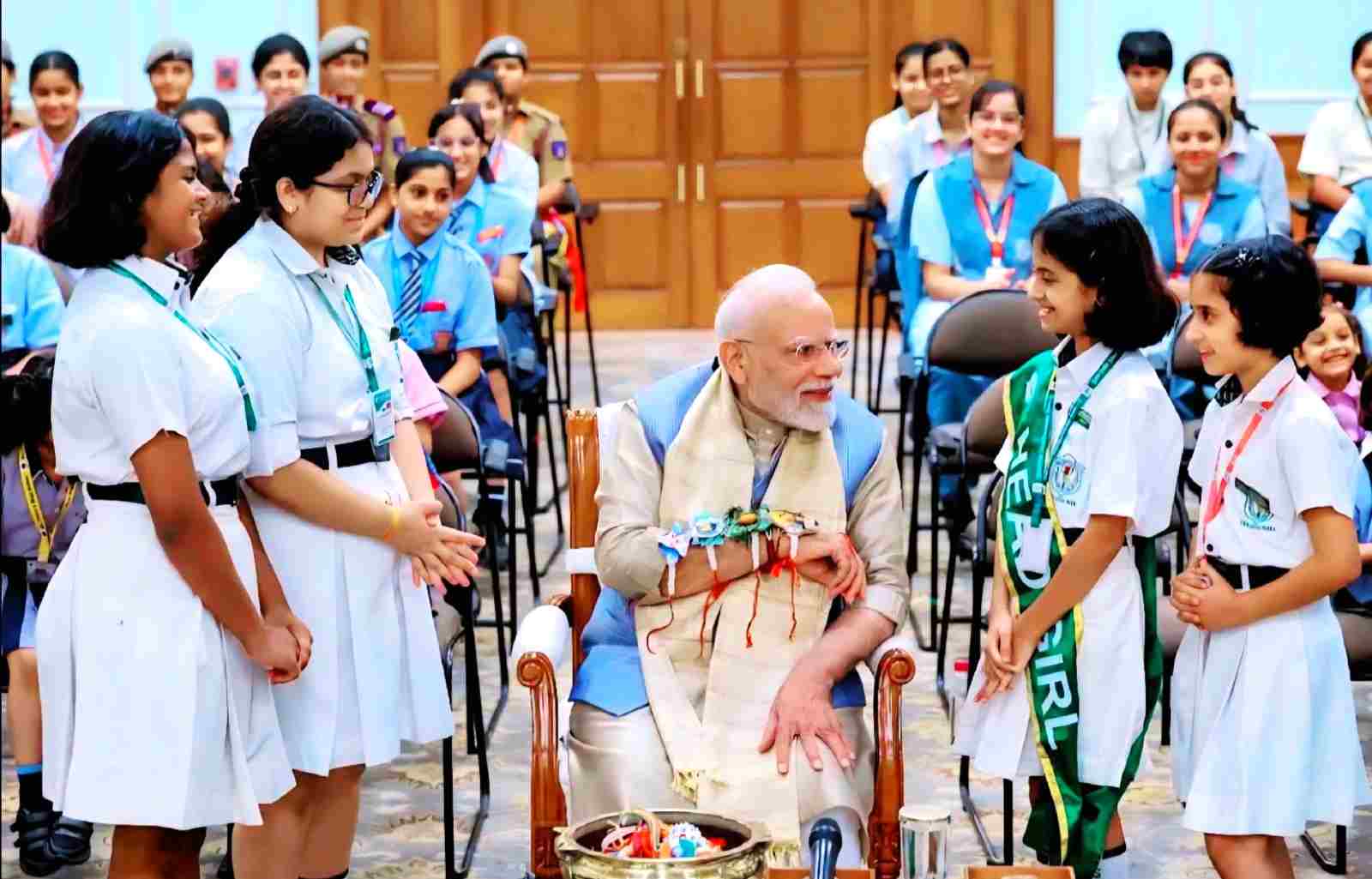 Prime Minister Narendra Modi gets a unique Rakhi tied by the children of DPS, Knowledge Park 5, and appreciates their initiatives in the field of AI and environment.
