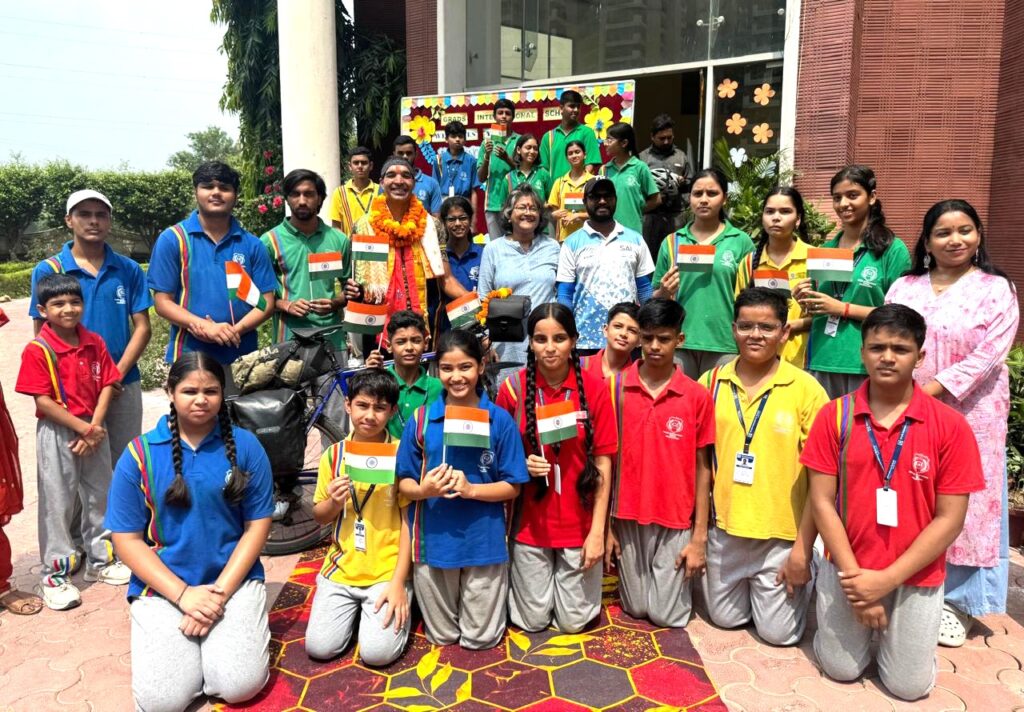 Schoolchildren welcome Zeno van der Zalm with the Tricolour on his arrival in Greater Noida