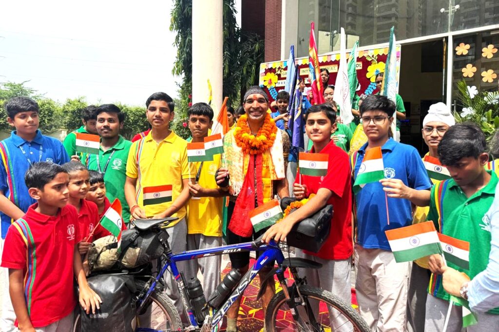 Schoolchildren welcome Zeno van der Zalm with the Tricolour on his arrival in Greater Noida
